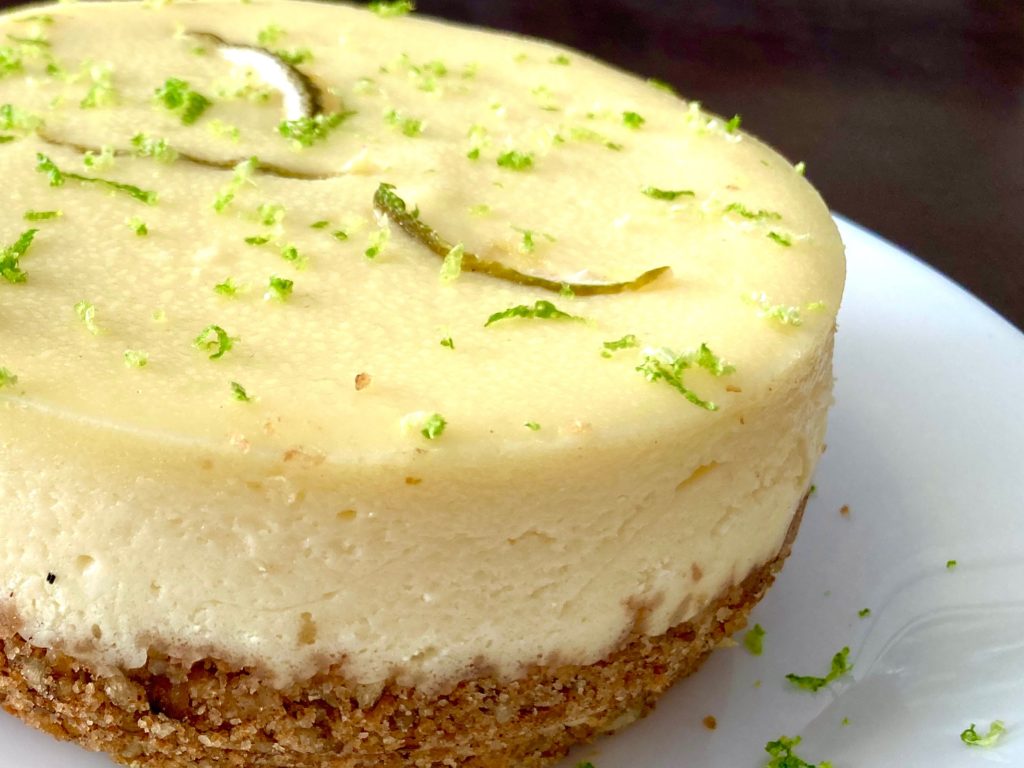 Key Lime Cheesecake with a graham cracker crust and sprinkling of lime zest. 