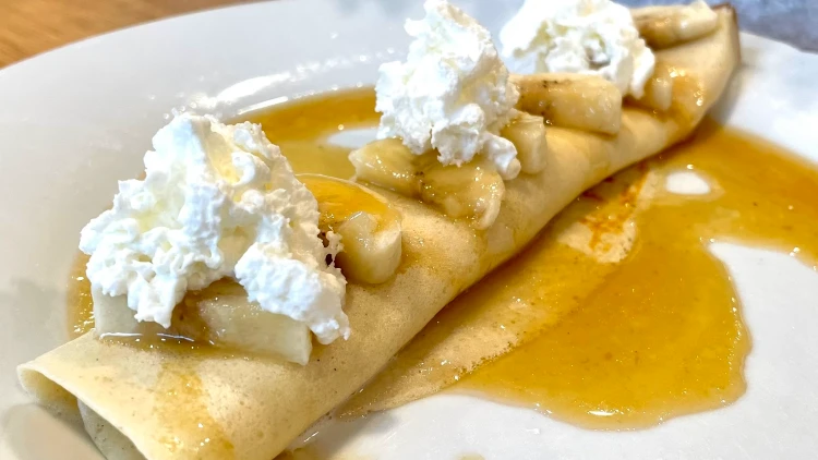 French crepe with Banana, whipped cream, and caramel syrup