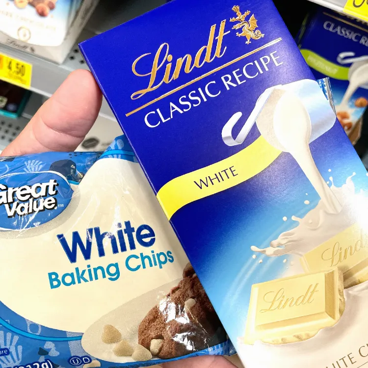 Display of inexpensive Great Value brand white baking chips and more expensive Lindt classic white chocolate